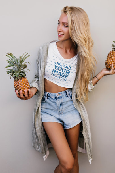 Crop Top Mockup of a Smiling Woman Holding Two Pineapples