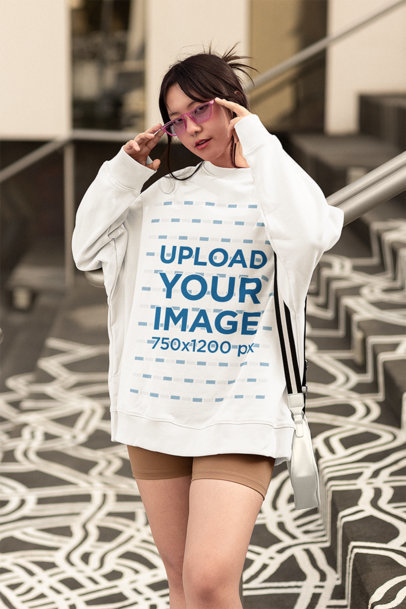 Mockup of a Woman Wearing an Oversized Sweatshirt and Pink Sunglasses m25235