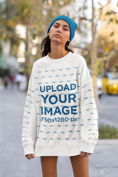 Mockup of a Slim Woman Wearing an Oversized Sweatshirt in the Street
