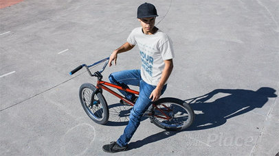 Young Man Wearing a Round Neck Tshirt Stop Motion While Sitting on His Bike