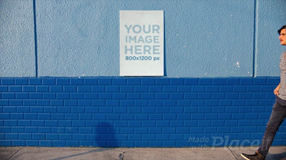 Stop Motion of a Poster Hanging on a Wall While a Man Walks By