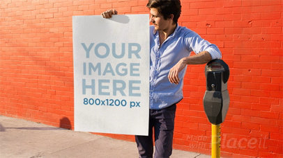 Young Man Holding a Poster Stop Motion While Leaning on a Parking Meter a13652