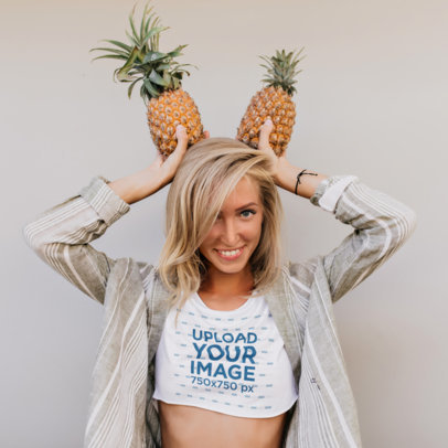 Crop Top Mockup of a Woman Holding Two Pineapples on Her Head