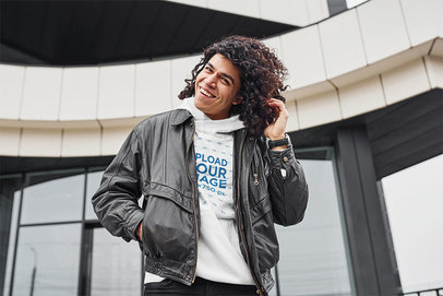 Hoodie Mockup of a Happy Man with Curly Hair Posing in Front of a Building