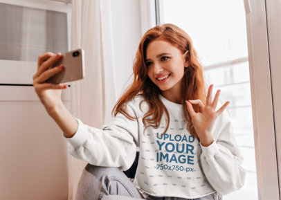 Sweatshirt Mockup Featuring a Happy Redhead Woman Taking a Selfie m13041 r-el2
