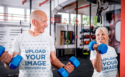 Round-Neck T-Shirt Mockup of a Happy Senior Couple Lifting Dumbbells