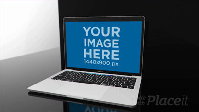 MacBook Pro Video Mockup Lying on a Black and Blue Room