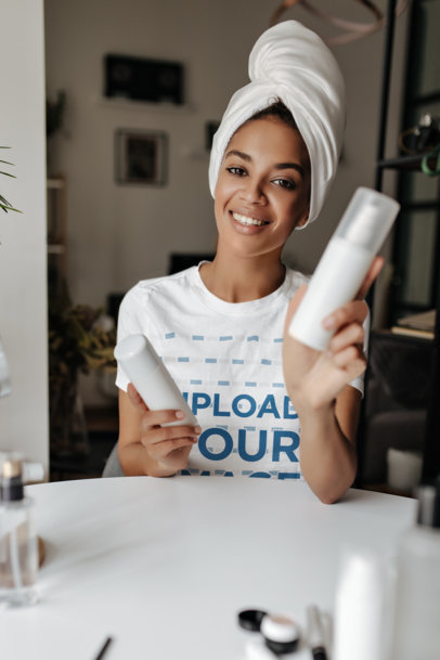 Round-Neck T-Shirt Mockup Featuring a Woman Holding Skincare Products