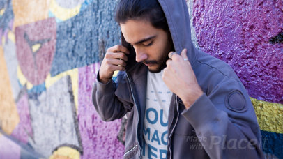 Trendy Guy Wearing a Round Neck T-Shirt Stop Motion Near a Graffiti Street Wall