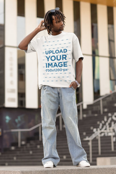 Mockup of a Man with Locs Wearing an Oversized T-shirt and Looking Serious