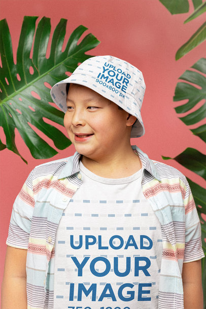 Bucket Hat Mockup Featuring a Happy Boy in a Tropical Setting