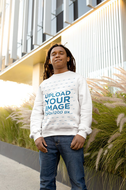 Sweatshirt Mockup of a Man with Locs Posing in Front of a Building
