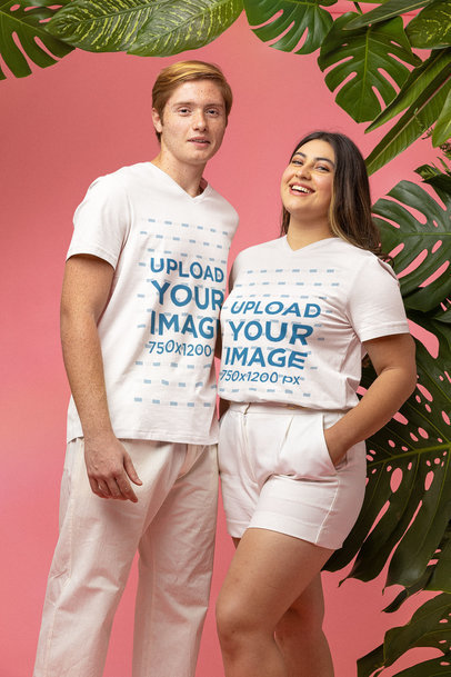 Mockup of a Happy Couple Wearing a V-Neck Tee at a Studio with Plants in the Background