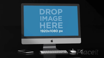 Video of an iMac Lying in a Black Room Near an iPhone and Earpads a15827b