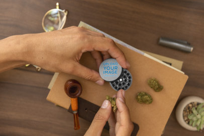 Mockup of a Man Holding a Grinder and a Cannabis Bud m25433