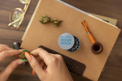 Mockup of a Grinder Featuring a Woman Holding a Cannabis Bud m25431
