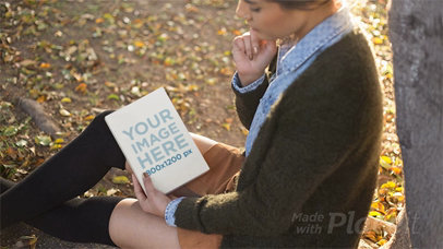 Young Woman Reading a Book in Stop Motion While at a Park In Autumn