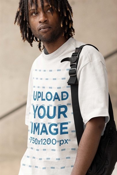 Mockup of a Serious Man with Locs  Wearing an Oversized Tee and Carrying a Bag