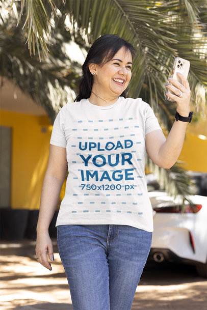 T-Shirt Mockup of a Happy Woman Checking Her Phone