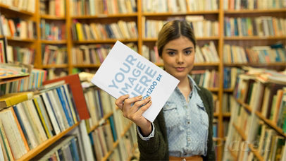College Woman Playing With a Book in Stop Motion Inside a Library