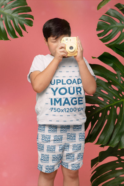 T-Shirt Mockup of a Boy Wearing Swim Trunks and Taking a Picture 