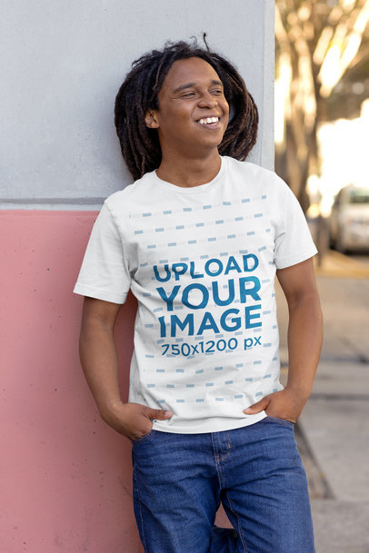 Bella Canvas T-Shirt Mockup of a Happy Man Leaning Against a Wall