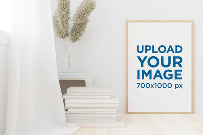 Mockup of an Art Print Frame Placed by Some Books in a Minimalist Setting