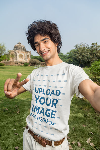 T-Shirt Mockup Featuring a Man Taking a Selfie in a Tourist Place m25832