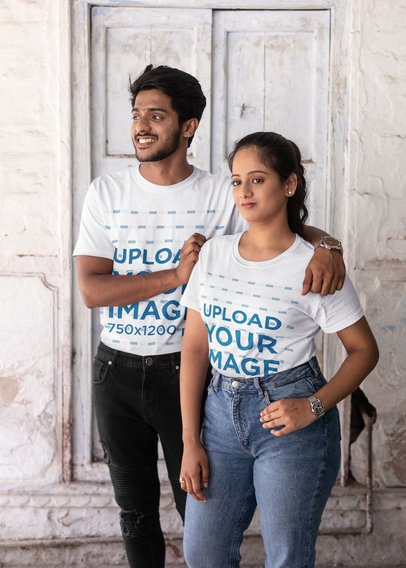 Mockup of a Couple Wearing T-shirts and Posing in Front of an Ancient Wall