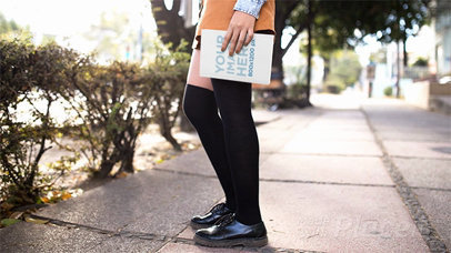 Young Woman Walking Covers Her Face With a Book in Stop Motion