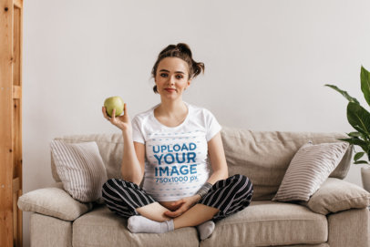 T-Shirt Mockup of a Pregnant Woman Sitting in Her Living Room