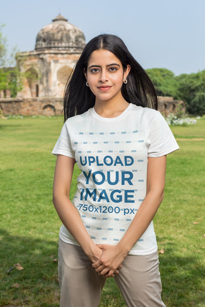 Round-Neck T-Shirt Mockup Featuring a Young Woman Standing Near a Temple