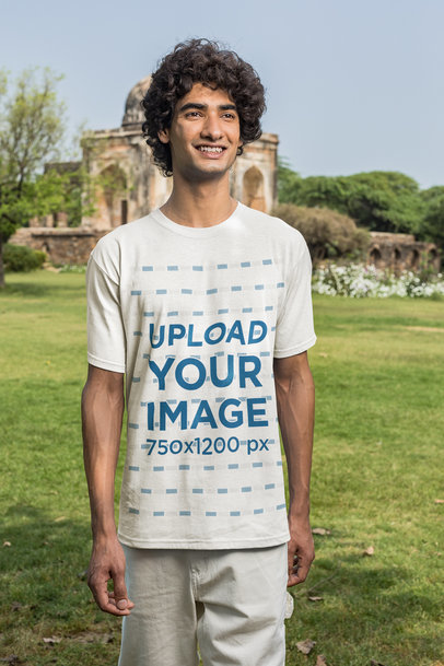 Mockup of a Man Wearing a Tee and Posing in front of a Temple 
