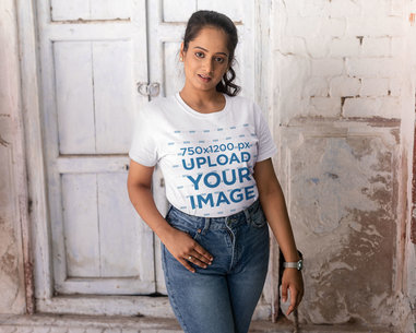 T-Shirt Mockup of a Woman Posing in Front of a White Wall