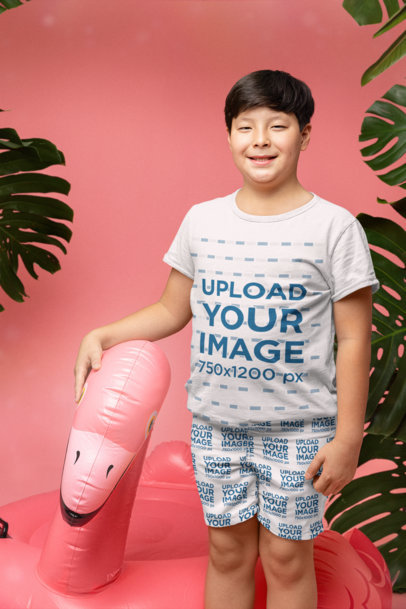 Swim Trunks Mockup of a Happy Boy Standing Next to a Pool Float and Wearing a Tee