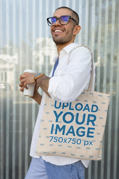 Sublimated Tote Bag Mockup of a Happy Man With Glasses Holding a Coffee Cup