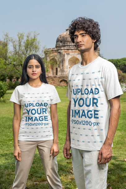 Mockup Featuring a Couple Wearing a T-Shirt and Posing in Front of a Big Garden and a Temple