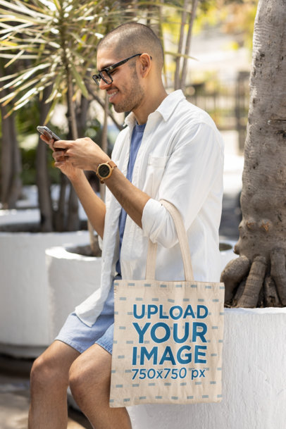 Tote Bag Mockup Featuring a Happy Man Texting