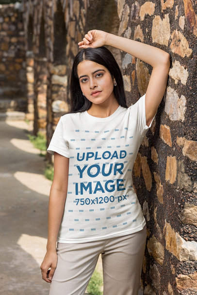 Round-Neck Tee Mockup of a Woman Leaning over a Rock Wall