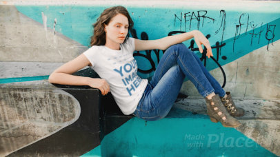 White Woman Sitting Down on a Skating Park Wearing a T-Shirt Cinemagraph