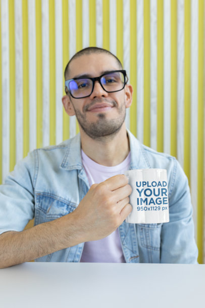 Mockup of a Man with Glasses Holding an 11 oz Coffee Mug