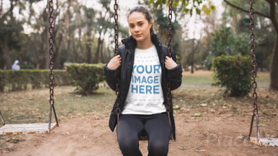 Pretty Woman Wearing a T-Shirt Cinemagraph Video Sitting Down in a Park's Hammock