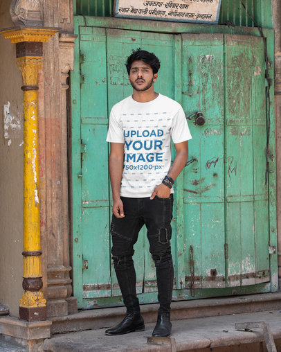 Mockup of a Man Wearing a Tee and Posing in Front of an Old Door