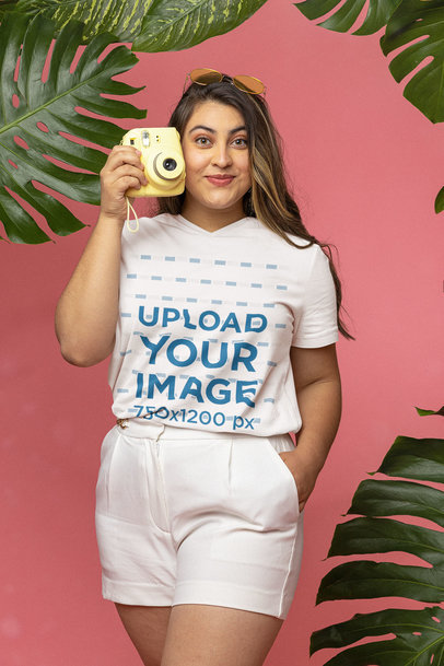 V-Neck T-Shirt Mockup of a Woman Posing with an Instant Camera in Her Hand