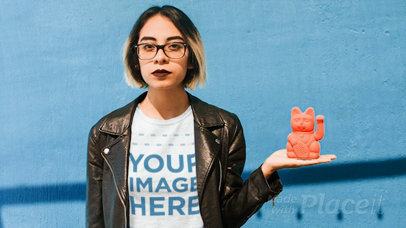 Young Woman with a  Leather Jacket Wearing a Tshirt Cinemagraph Holding a Manekineko