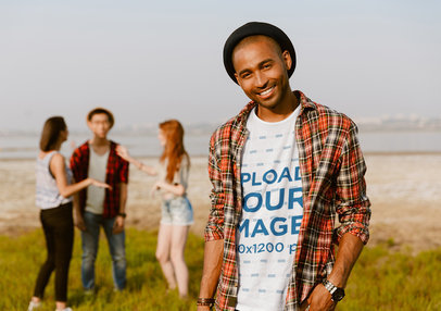 T-Shirt Mockup Featuring a Man Smiling in a Natural Landscape