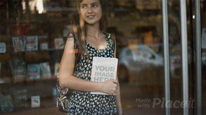 Young Woman Holding a Book in Stop Motion While at a Library
