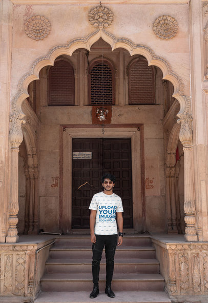 Sublimated Tee Mockup of a Serious Man Posing in Front of a Mosque