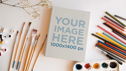 Book on a Creative Painter Desk with Brushes Palette and Pencils Moving in Stop Motion