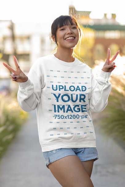 Sweatshirt Mockup Featuring a Young Woman Making Peace Signs